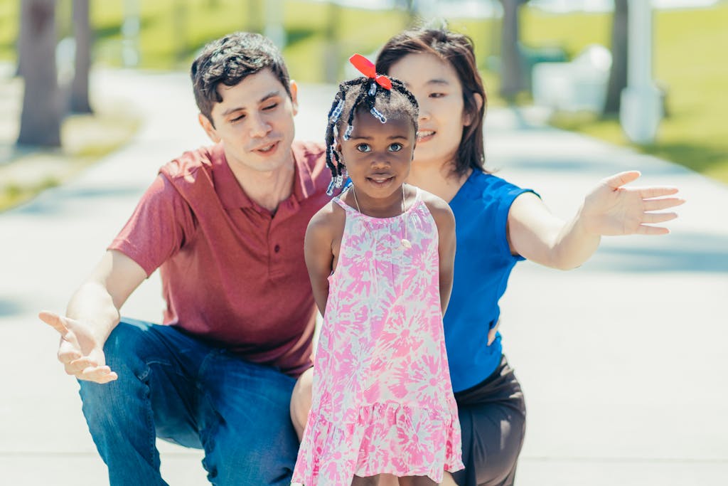 A multiracial family shares joyful bonding moments outdoors on a sunny day.