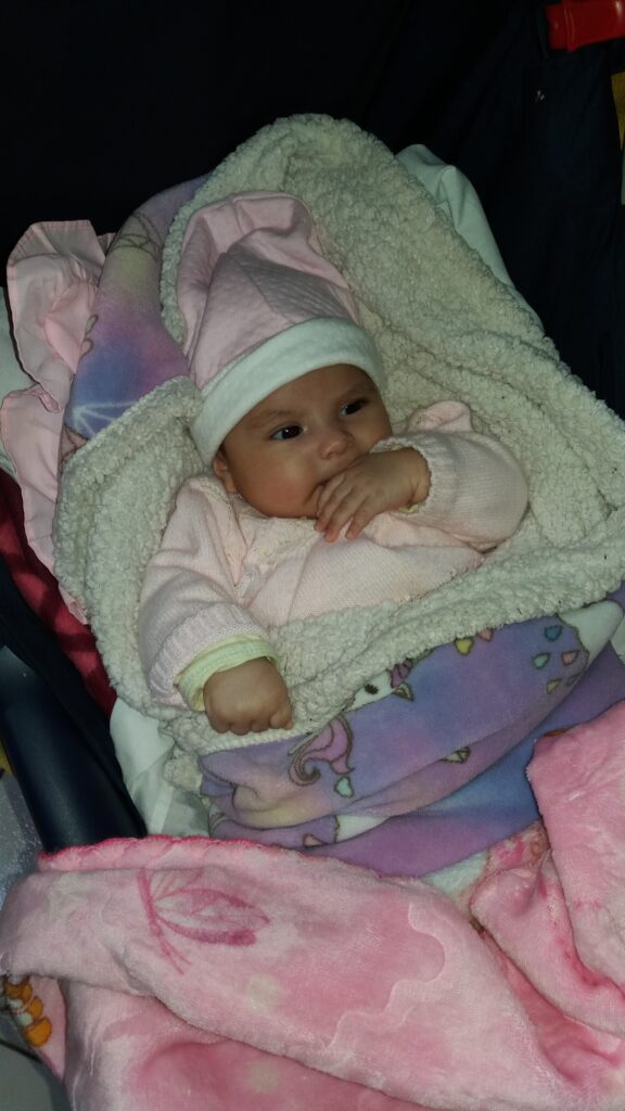 Baby bundled in blankets at Restoring Children International