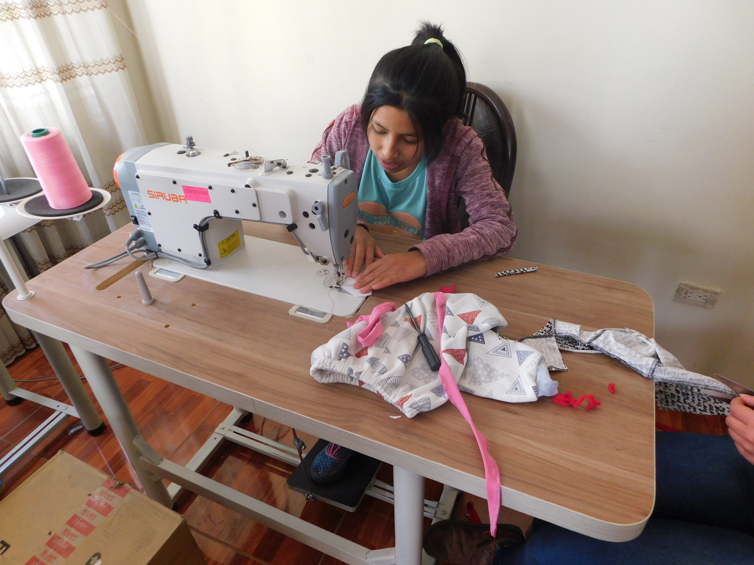 Girl learning vocational skills at Restoring Children International